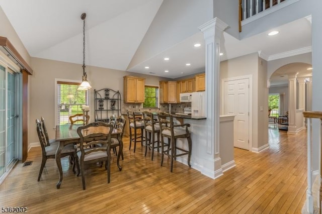 2 Moore Dr, Raritan Twp, NJ 08822 - dining area featuring light wood finished floors, decorative columns, arched walkways, high vaulted ceiling, and recessed lighting