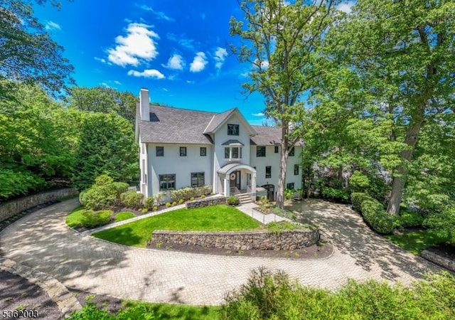 60 Fernwood Rd, Summit City, NJ 07901 - view of front of home with stucco siding, a chimney, and a front lawn