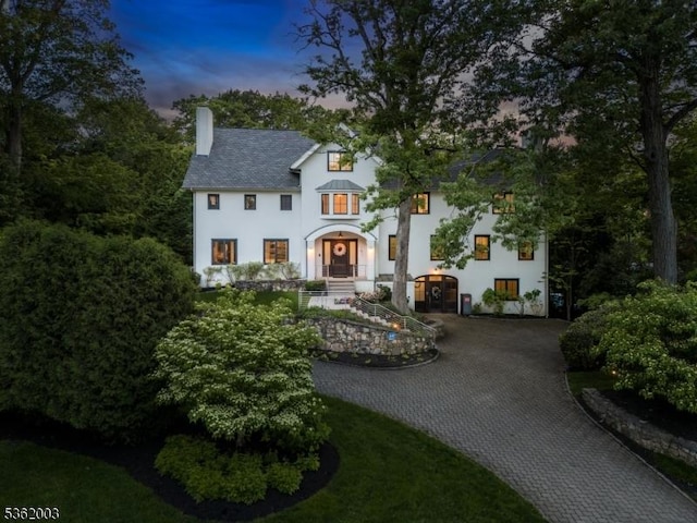 60 Fernwood Rd, Summit City, NJ 07901 - view of front facade with a chimney, stucco siding, and decorative driveway
