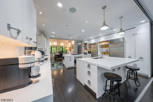 60 Fernwood Rd, Summit City, NJ 07901 - kitchen with high quality fridge, a sink, an island with sink, modern cabinets, and dark wood-style flooring
