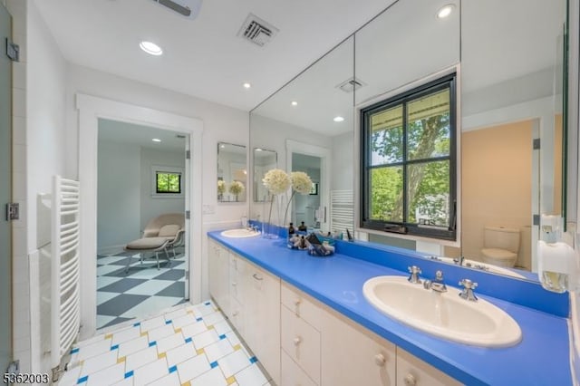 60 Fernwood Rd, Summit City, NJ 07901 - full bath with a towel warming rack, double vanity, tile patterned floors, recessed lighting, and toilet