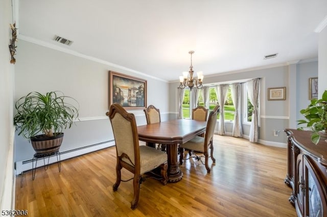 5 Mariner Dr, Randolph Twp, NJ 07869 - dining room with a baseboard heating unit, a chandelier, crown molding, light wood-style flooring, and baseboards