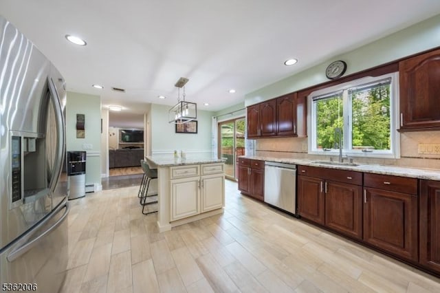 5 Mariner Dr, Randolph Twp, NJ 07869 - kitchen featuring appliances with stainless steel finishes, tasteful backsplash, light stone countertops, a breakfast bar area, and recessed lighting