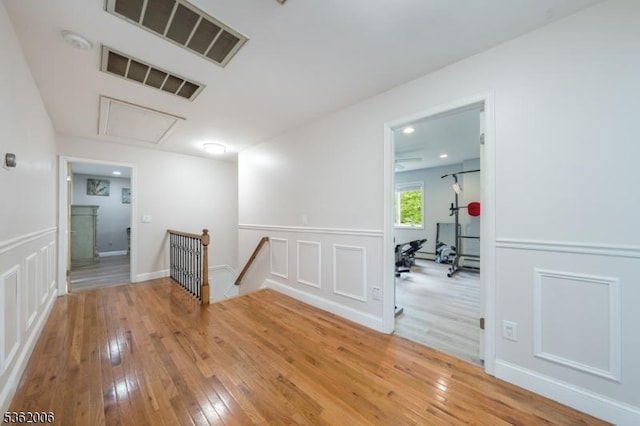 5 Mariner Dr, Randolph Twp, NJ 07869 - corridor featuring an upstairs landing, hardwood / wood-style flooring, a decorative wall, and a wainscoted wall