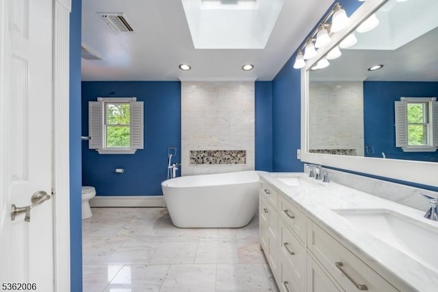 5 Mariner Dr, Randolph Twp, NJ 07869 - bathroom with a skylight, double vanity, a freestanding tub, toilet, and recessed lighting