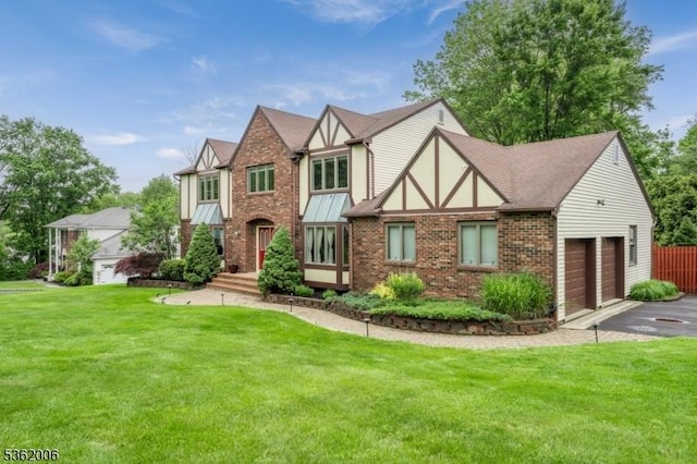 5 Mariner Dr, Randolph Twp, NJ 07869 - tudor house featuring an attached garage, driveway, brick siding, a front yard, and a shingled roof