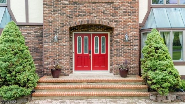 5 Mariner Dr, Randolph Twp, NJ 07869 - doorway to property with brick siding, stucco siding, and a standing seam roof