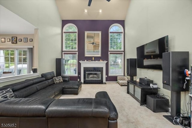 14 Barn Swallow Ct, Greenwich Twp, NJ 08886 - carpeted living room with ceiling fan, a fireplace with flush hearth, and a high ceiling