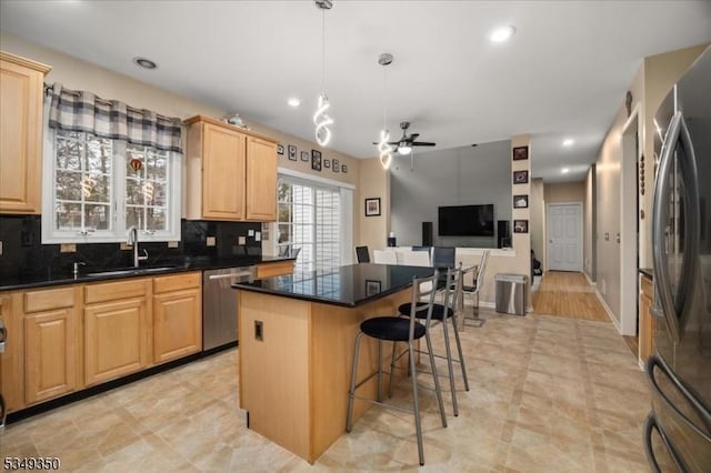 14 Barn Swallow Ct, Greenwich Twp, NJ 08886 - kitchen featuring stainless steel appliances, light brown cabinetry, a sink, a kitchen island, and decorative backsplash