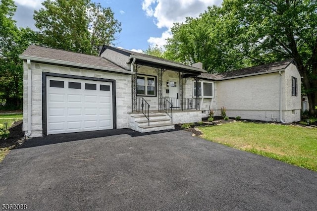 144 Elm St, Rockaway Twp, NJ 07801 - ranch-style home with an attached garage, driveway, a front lawn, and a porch