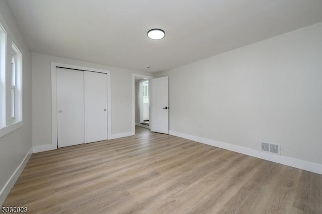 144 Elm St, Rockaway Twp, NJ 07801 - unfurnished bedroom featuring baseboards, light wood-type flooring, and a closet