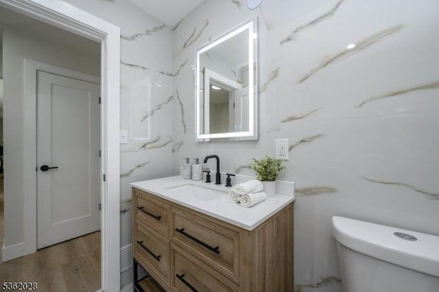 144 Elm St, Rockaway Twp, NJ 07801 - bathroom featuring vanity, toilet, and wood finished floors