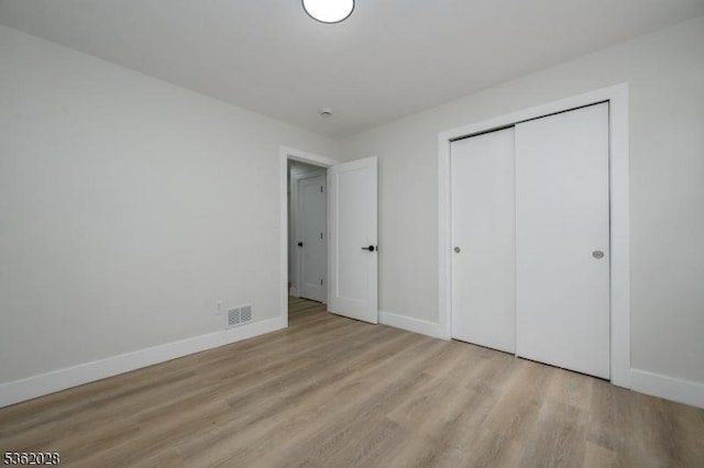 144 Elm St, Rockaway Twp, NJ 07801 - unfurnished bedroom featuring light wood-style flooring, baseboards, and a closet