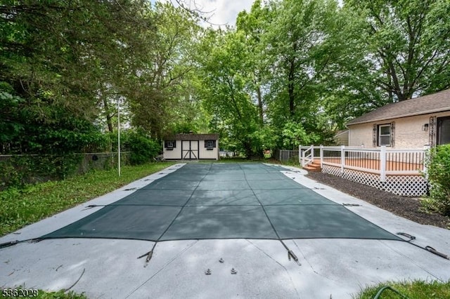 144 Elm St, Rockaway Twp, NJ 07801 - view of swimming pool with a wooden deck, view of scattered trees, and a patio