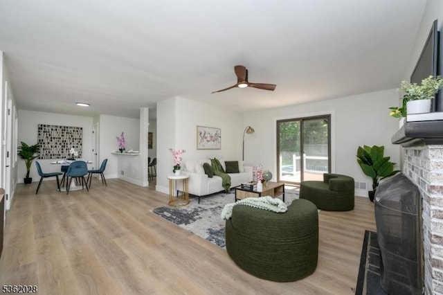 144 Elm St, Rockaway Twp, NJ 07801 - living area featuring light wood-style floors, ceiling fan, a fireplace, and baseboards