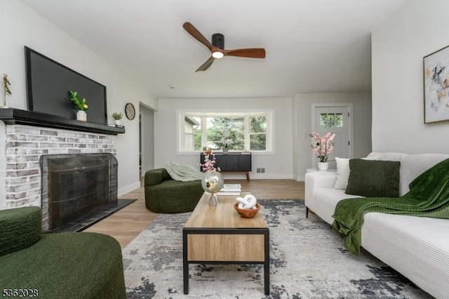 144 Elm St, Rockaway Twp, NJ 07801 - living area featuring ceiling fan, wood finished floors, a brick fireplace, and baseboards