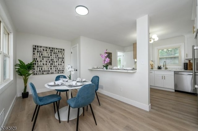 144 Elm St, Rockaway Twp, NJ 07801 - dining space with light wood-style flooring and baseboards