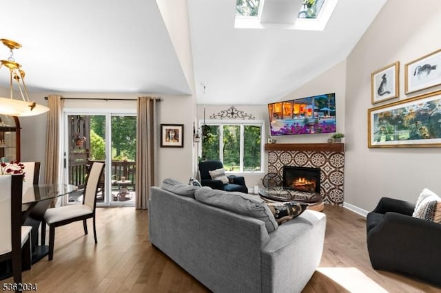 18 Inverrary Pl, Clinton Twp, NJ 08801 - living area featuring a skylight, a tile fireplace, healthy amount of natural light, wood finished floors, and high vaulted ceiling