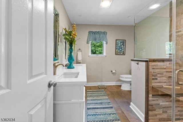 18 Inverrary Pl, Clinton Twp, NJ 08801 - bathroom featuring double vanity, toilet, a shower stall, wood finished floors, and baseboards