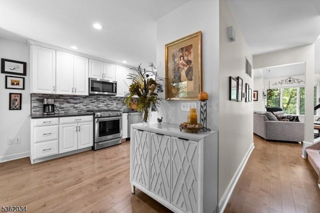 18 Inverrary Pl, Clinton Twp, NJ 08801 - kitchen with appliances with stainless steel finishes, light wood-style flooring, decorative backsplash, baseboards, and white cabinetry