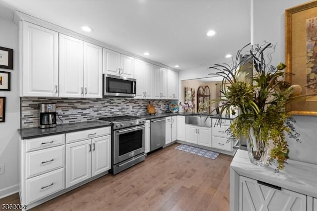 18 Inverrary Pl, Clinton Twp, NJ 08801 - kitchen featuring stainless steel appliances, tasteful backsplash, white cabinets, light wood-type flooring, and recessed lighting