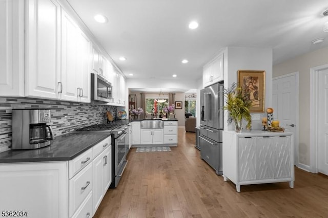 18 Inverrary Pl, Clinton Twp, NJ 08801 - kitchen with premium appliances, a sink, a peninsula, white cabinets, and recessed lighting