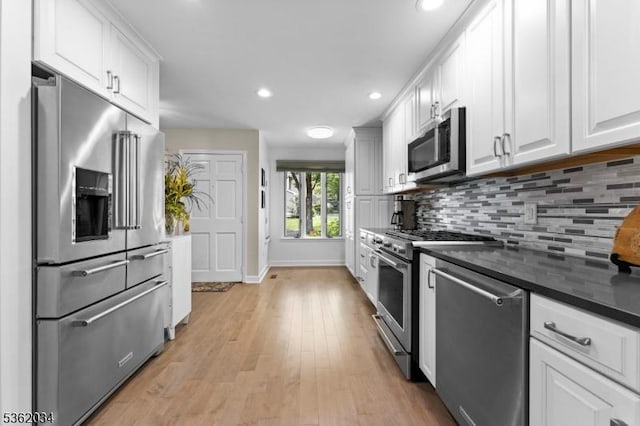 18 Inverrary Pl, Clinton Twp, NJ 08801 - kitchen featuring high end appliances, dark countertops, baseboards, backsplash, and light wood finished floors