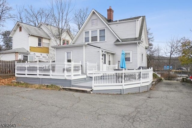 67 Parsippany Rd, Hanover Twp, NJ 07981 - rear view of house with a chimney and a deck