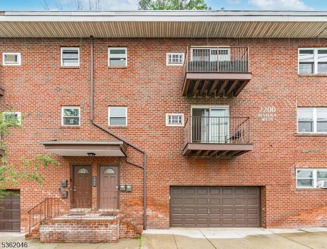 2200 Paterson Plank Rd Unit 23, North Bergen Twp, NJ 07047 - view of property featuring an attached garage and concrete driveway