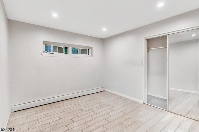 2200 Paterson Plank Rd Unit 23, North Bergen Twp, NJ 07047 - unfurnished bedroom featuring a baseboard heating unit, recessed lighting, wood finished floors, a closet, and baseboards