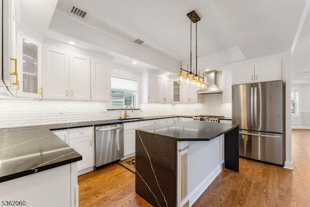 1537 Franklin St, Clark Twp, NJ 07066 - kitchen featuring appliances with stainless steel finishes, wall chimney exhaust hood, dark countertops, white cabinetry, and crown molding