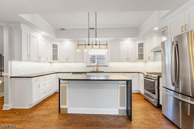 1537 Franklin St, Clark Twp, NJ 07066 - kitchen with stainless steel appliances, white cabinetry, crown molding, decorative backsplash, and wood finished floors