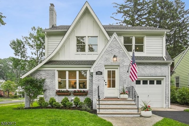701 High St, Cranford Twp, NJ 07016 - view of front of house with board and batten siding, a garage, a chimney, asphalt driveway, and brick siding