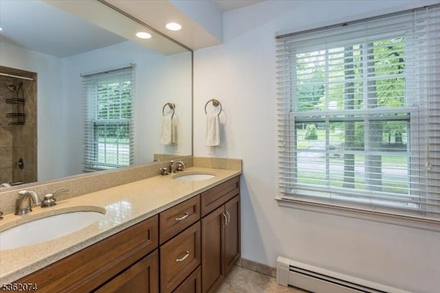 31 Winay Ter, Washington Twp, NJ 07853 - full bathroom featuring a baseboard heating unit, double vanity, healthy amount of natural light, and a shower