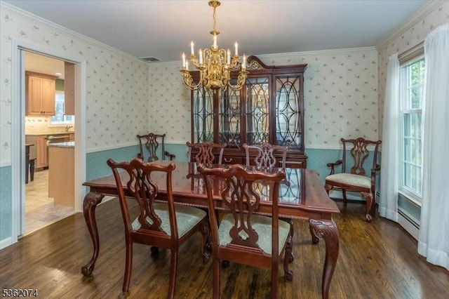 31 Winay Ter, Washington Twp, NJ 07853 - dining area with a chandelier, wood finished floors, wallpapered walls, crown molding, and a baseboard heating unit