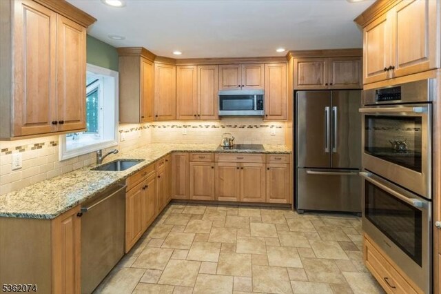 31 Winay Ter, Washington Twp, NJ 07853 - kitchen with stainless steel appliances, stone finish floors, light stone countertops, tasteful backsplash, and recessed lighting