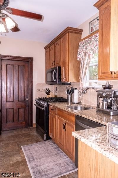 24 Ryerson Ave, Newton Town, NJ 07860 - kitchen with gas stove, a sink, ceiling fan, stainless steel microwave, and backsplash