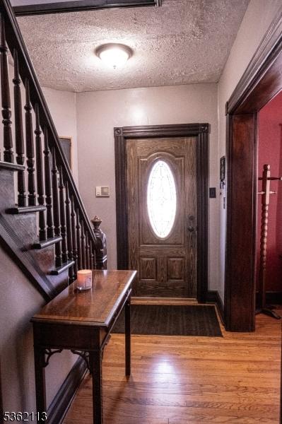 24 Ryerson Ave, Newton Town, NJ 07860 - foyer entrance featuring wood finished floors, a textured ceiling, and stairs