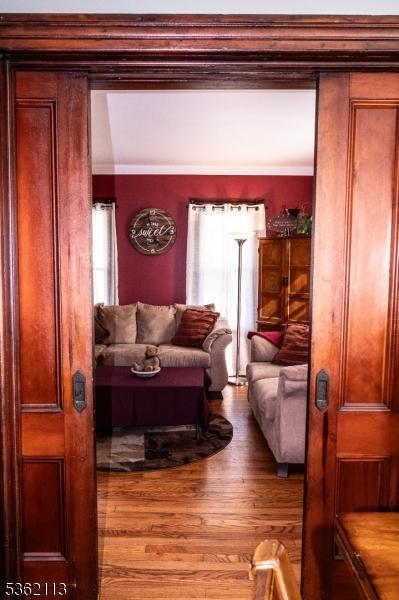 24 Ryerson Ave, Newton Town, NJ 07860 - living room featuring wood finished floors, healthy amount of natural light, and crown molding