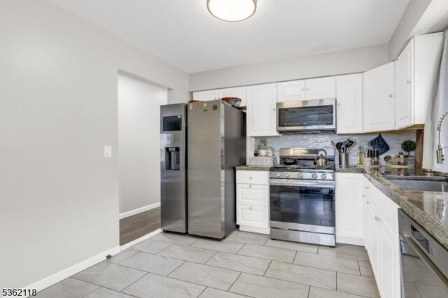 1105 Essex Ave Unit 2, Linden City, NJ 07036 - kitchen featuring stainless steel appliances, a sink, white cabinets, tasteful backsplash, and dark countertops