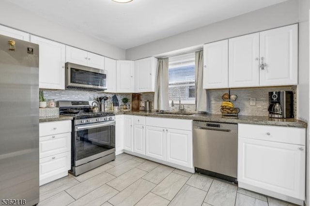 1105 Essex Ave Unit 2, Linden City, NJ 07036 - kitchen with stainless steel appliances, a sink, tasteful backsplash, and white cabinets