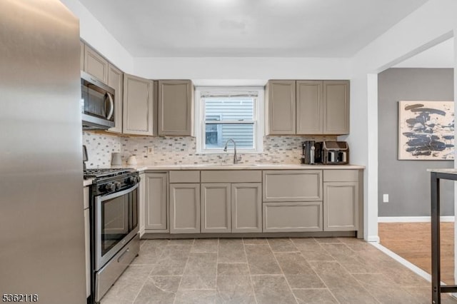 1105 Essex Ave Unit 2, Linden City, NJ 07036 - kitchen featuring stainless steel appliances, a sink, backsplash, gray cabinets, and light countertops