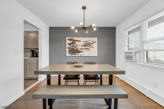 1105 Essex Ave Unit 2, Linden City, NJ 07036 - dining space with baseboard heating, a chandelier, wood finished floors, cooling unit, and baseboards