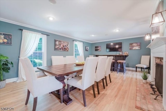 17 Olsen Dr, Warren Twp, NJ 07059 - dining space featuring light wood-style floors, crown molding, baseboards, a fireplace with raised hearth, and recessed lighting