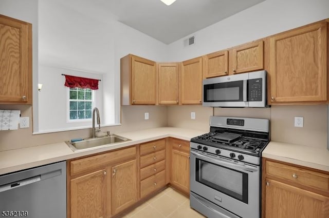231 Swathmore Dr, Nutley Twp, NJ 07110 - kitchen featuring stainless steel appliances, light countertops, and light tile patterned flooring