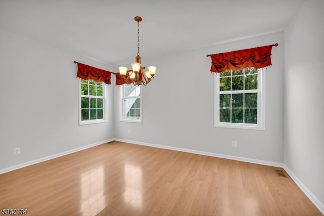 231 Swathmore Dr, Nutley Twp, NJ 07110 - spare room featuring a chandelier and light wood-style floors