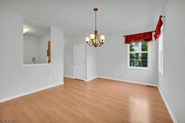 231 Swathmore Dr, Nutley Twp, NJ 07110 - spare room featuring light wood-style flooring and a chandelier
