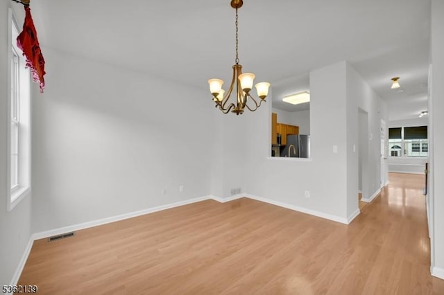231 Swathmore Dr, Nutley Twp, NJ 07110 - empty room featuring light wood-style floors and a chandelier