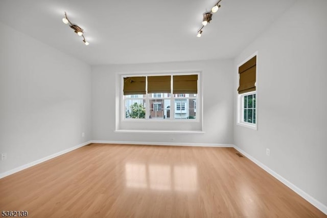 231 Swathmore Dr, Nutley Twp, NJ 07110 - unfurnished room with rail lighting, healthy amount of natural light, and light wood-type flooring