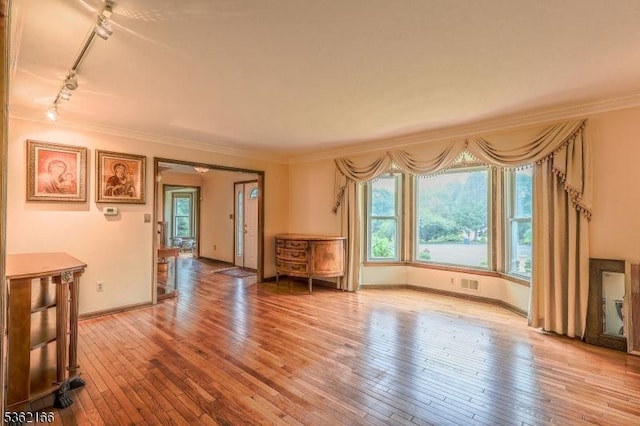 1 Willow Brook Ln, Clinton Twp, NJ 08801 - unfurnished living room with rail lighting, crown molding, and wood-type flooring